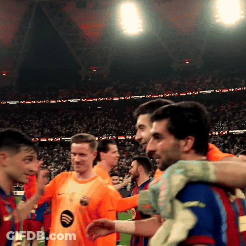 Soccer Players Huddled In Stadium With Spotify Logo GIF