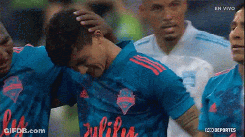 Soccer Players Huddled With Julius Jersey GIF
