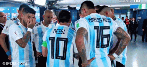 Soccer Players Huddled With Messi In Locker Room GIF