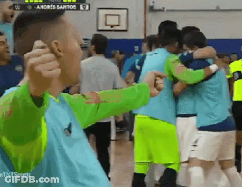 Soccer Players Hugging In Front Of Andreis Santos Scoreboard GIF