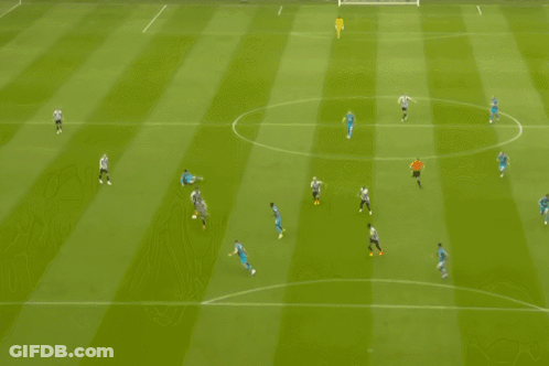 Soccer Players Hugging In Front Of Newcastle Sign GIF