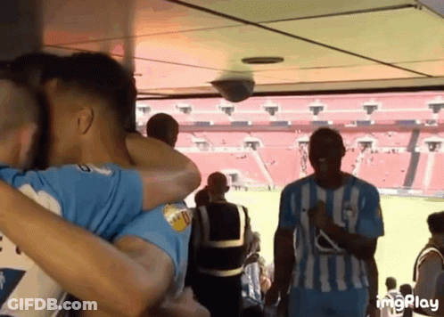 Soccer Players Hugging In Stadium GIF