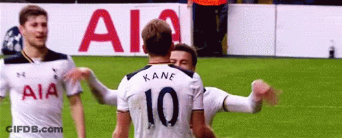 Soccer Players Hugging On Field GIF