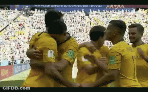 Soccer Players Hugging On Field With Crowd GIF