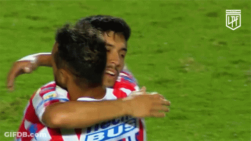 Soccer Players Hugging, One Wearing Bus Shirt GIF