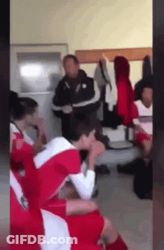 Soccer Players In Locker Room With Heads Down GIF