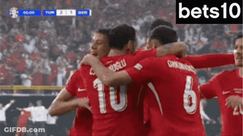 Soccer Players In Red Jerseys 10 And 6 Hugging GIF
