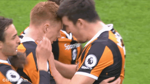 Soccer Players In Umbro Jerseys Hugging GIF