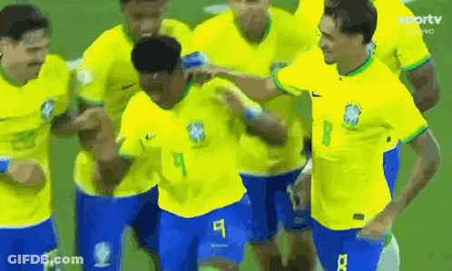 Soccer Players In Yellow And Blue Celebrating Goal GIF