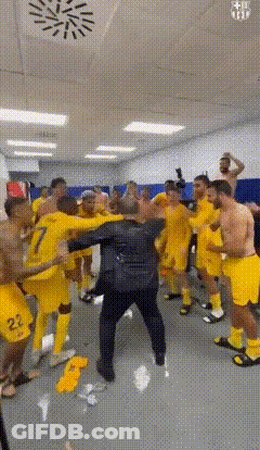 Soccer Players In Yellow Uniforms Dancing In Locker Room GIF