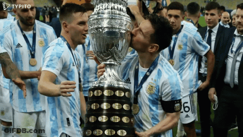 Soccer Players Kissing A Trophy With The Number 6 On Their Shirt GIF