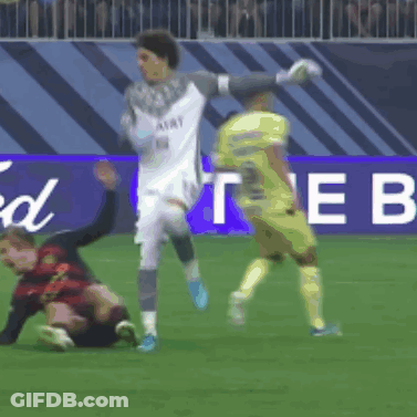 Soccer Players On A Field In Front Of A Sign That Says The B GIF