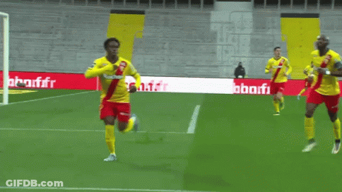 Soccer Players On A Field With A Banner That Says Auchan GIF