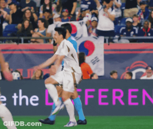 Soccer Players On A Field With A Banner That Says The Difference GIF