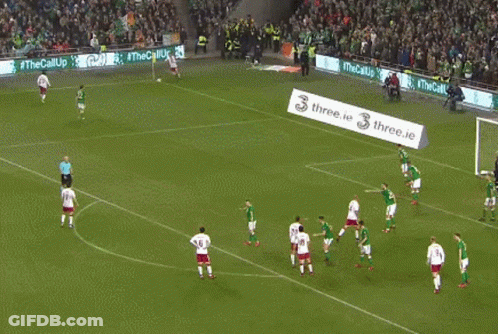Soccer Players On A Field With A Banner That Says Three.ie On It GIF