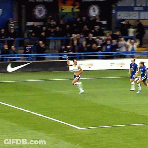Soccer Players On A Field With A Nike Banner In The Background GIF