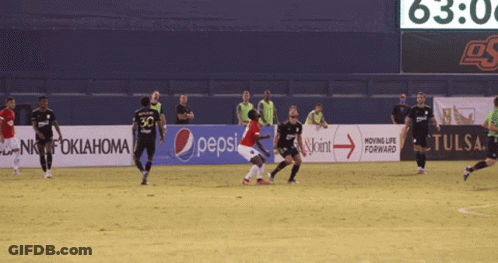 Soccer Players On A Field With A Pepsi Banner GIF