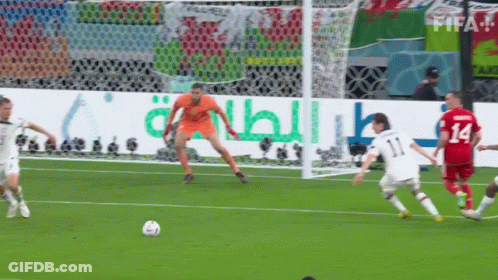 Soccer Players On A Field With A Qatar Energy Banner In The Background GIF