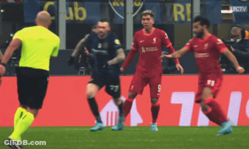 Soccer Players On A Field With A Yellow Referee And A Sign That Says Club GIF