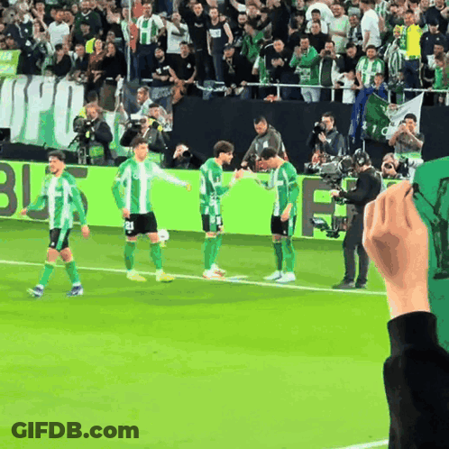 Soccer Players On Field With Banner Saying Jfu GIF