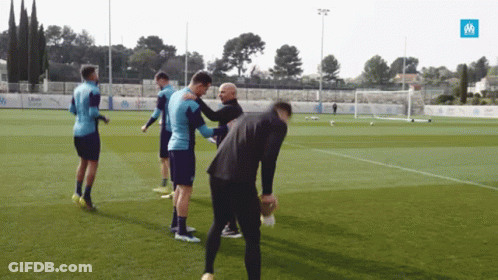 Soccer Players On Field With Blue Uber Sign GIF