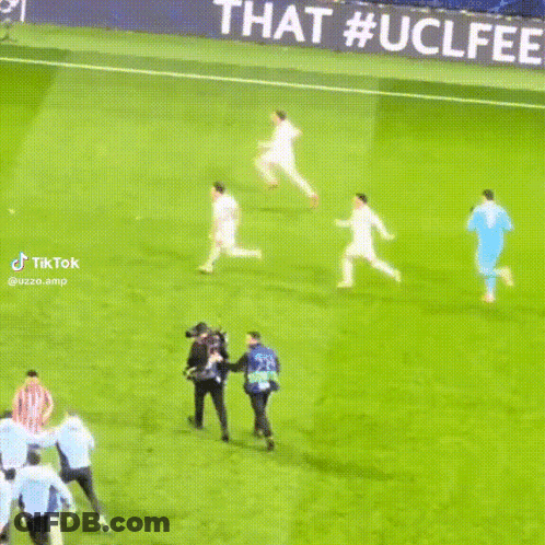 Soccer Players On Field With Champions League Banner GIF