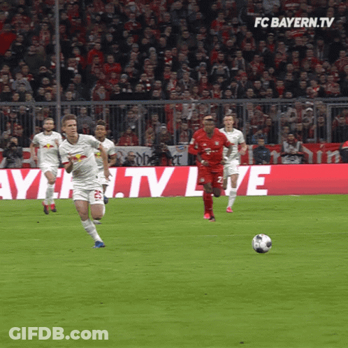 Soccer Players On Field With FC Bayern.tv Background GIF