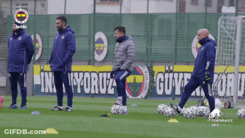 Soccer Players On Field With Fenerbahce Banner GIF