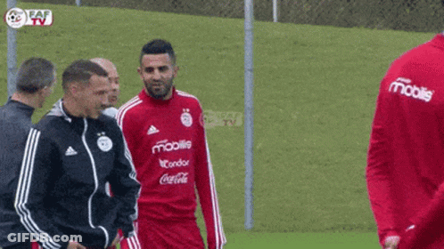 Soccer Players On Field With Mobile Shirt GIF