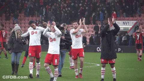 Soccer Players On Field With NV1 Sign GIF