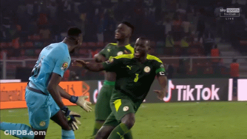 Soccer Players On Field With TikTok Sign GIF