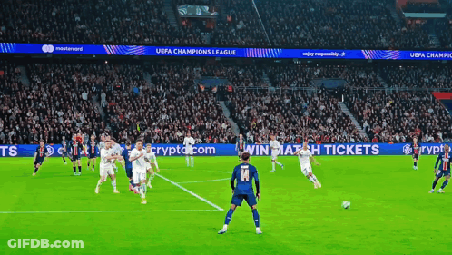 Soccer Players On Field With UEFA Champions League Banners GIF