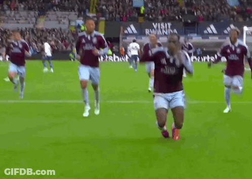Soccer Players On Field With Visit Rwanda Sign GIF