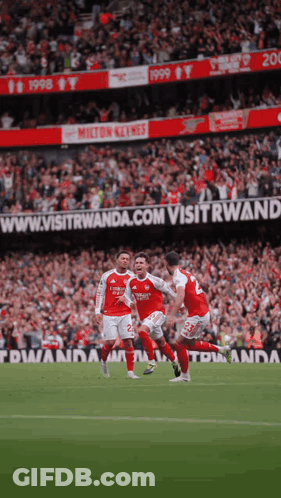 Soccer Players On Field With Visitwanda.com Banner GIF