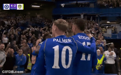 Soccer Players Palmer And Rogers Hugging In Front Of Crowd GIF