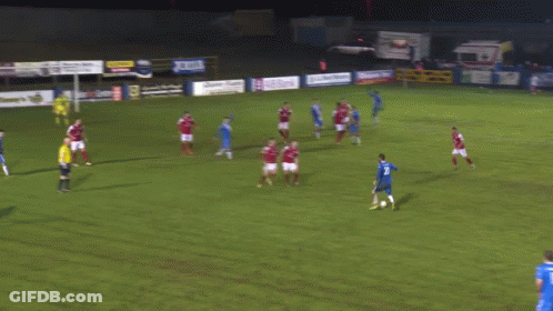 Soccer Players Playing Near Rip Timmy's Sign GIF