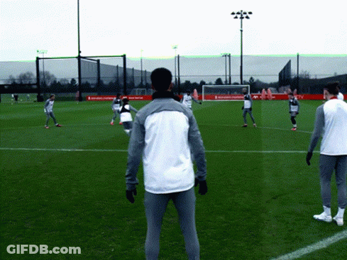 Soccer Players Playing On Field With Coca Cola Banner GIF
