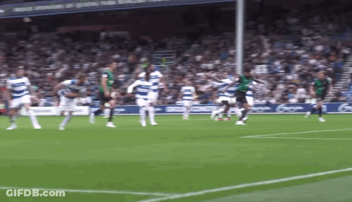 Soccer Players Playing On Field With Sponsors Of Queens Park Sign GIF