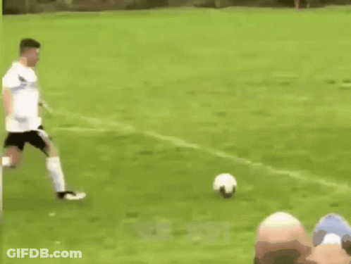 Soccer Players Playing, One Kneeling GIF