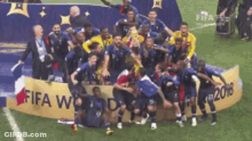 Soccer Players Posing In Front Of FIFA World Cup Banner GIF