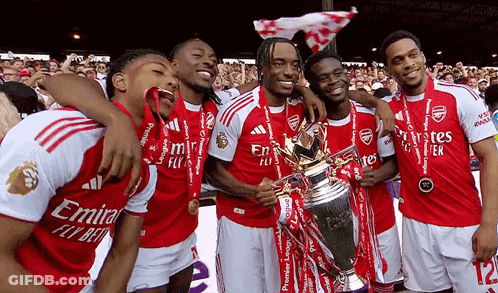 Soccer Players Posing With Emirates Fly Bet Trophy GIF
