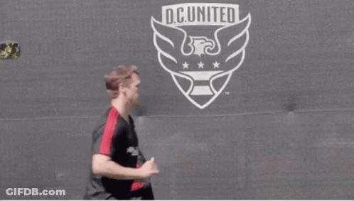 Soccer Players Running In Front Of D.C. United Logo GIF