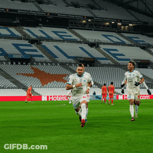 Soccer Players Running On A Field With Uber Eats Written On Their Jerseys GIF