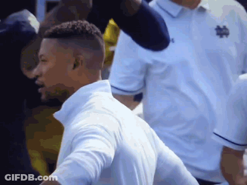 Soccer Players Running On Field In Front Of Crowd GIF