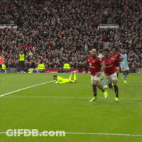 Soccer Players Running On Field In Front Of Crowd GIF