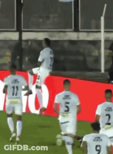 Soccer Players Running On Field Number 9 GIF