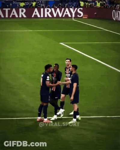 Soccer Players Shaking Hands On A Field With An Advertisement For Qatar Airways In The Background GIF