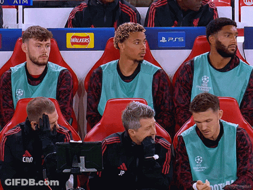 Soccer Players Sitting In Locker Room With Walkers And PS5 Logos GIF