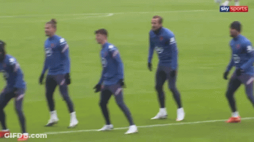Soccer Players Standing On Field With Sky Sports Logo GIF