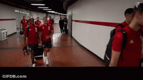 Soccer Players Walking Hallway Red Shirts GIF